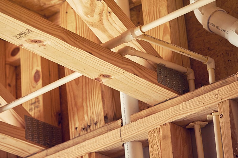 Close up view of building wood structure with CPVC piping